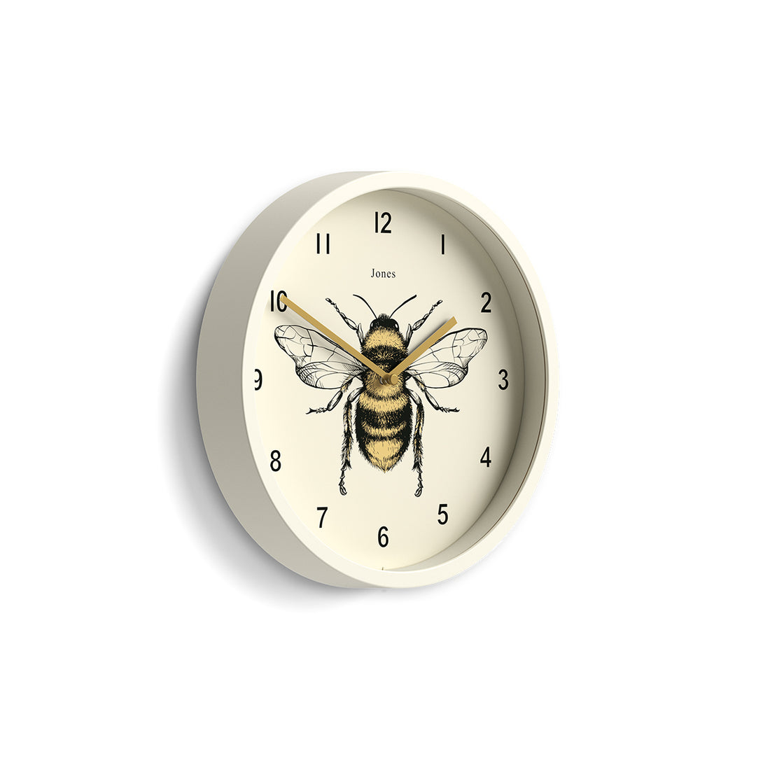 Side view of the Bee wall clock by Jones Clocks with a linen white case and modern bee dial - JDRAG277LW