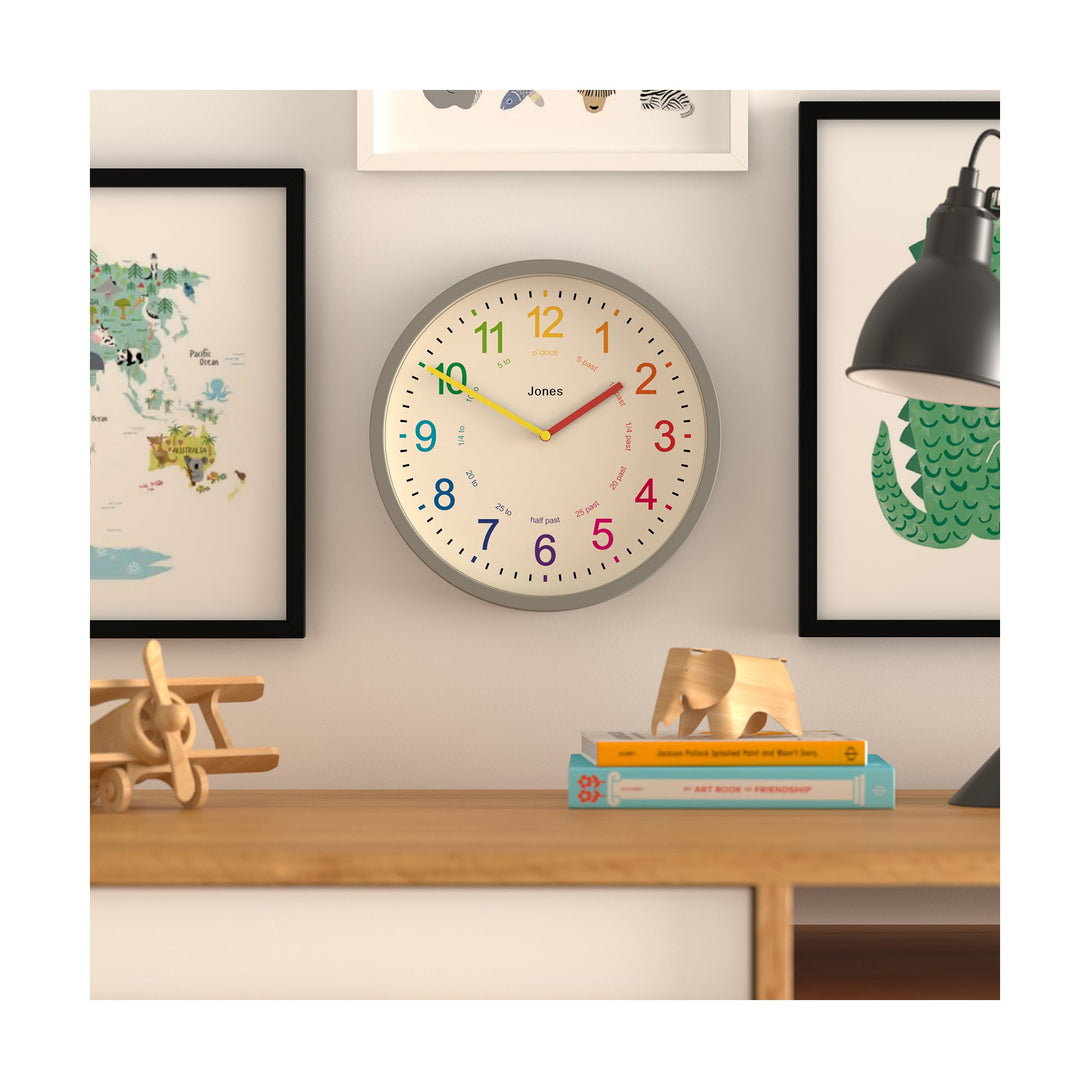 Kids wall clock by Jones Clocks in grey with a multi-coloured, easy-to-read dial - JDRAG73PGY