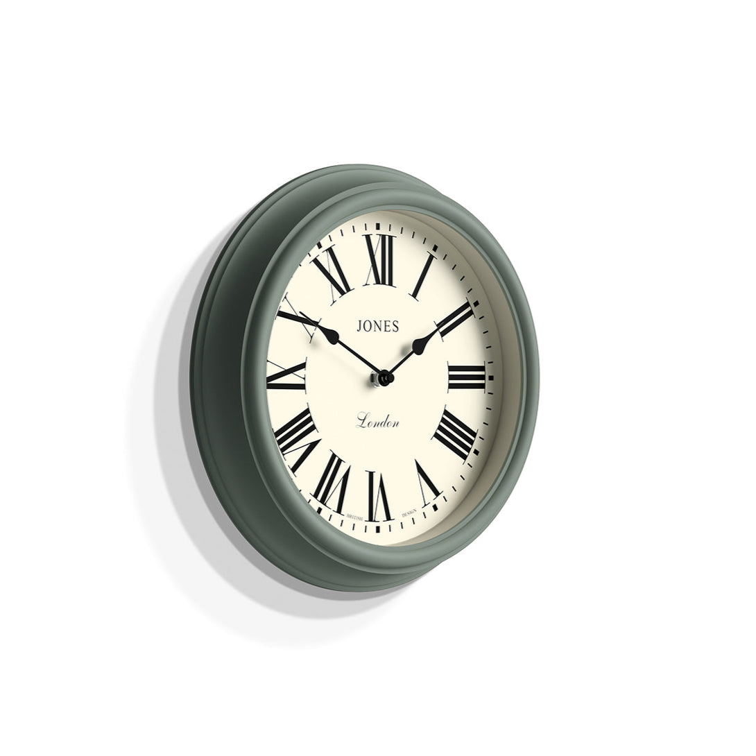 Skew - Venetian wall clock by Jones Clocks. A classic Roman numeral dial with traditional spade hands, inside a decorative moss green case - JVEN319ASG