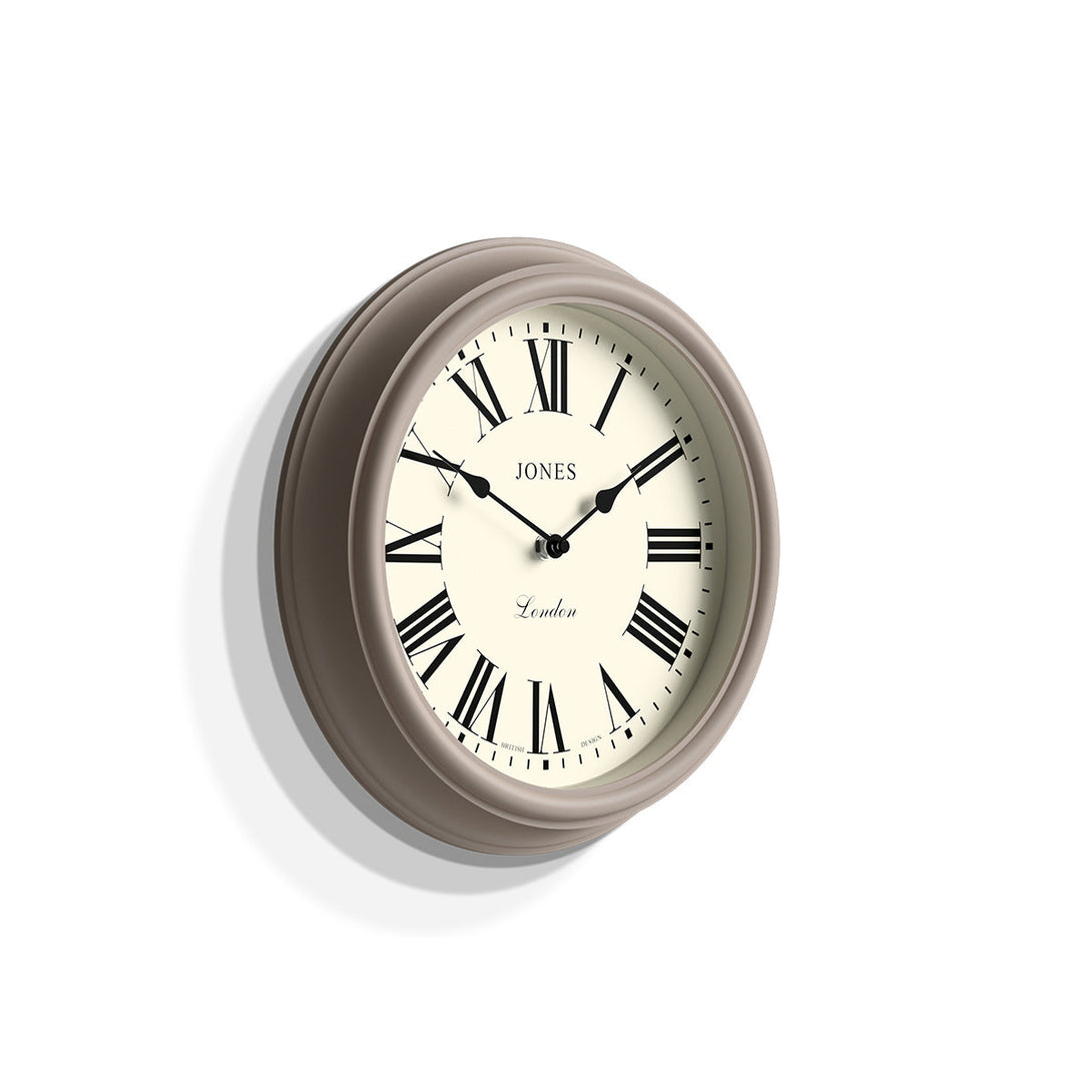 Skew - Venetian wall clock by Jones Clocks. A classic Roman numeral dial with traditional spade hands, inside a decorative 'mole grey' beige case - JVEN319ST