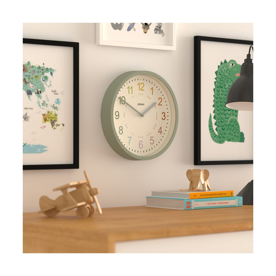 Kids wall clock by Jones Clocks in sage green with a multi-coloured, easy-to-read dial - JDRAG180DS