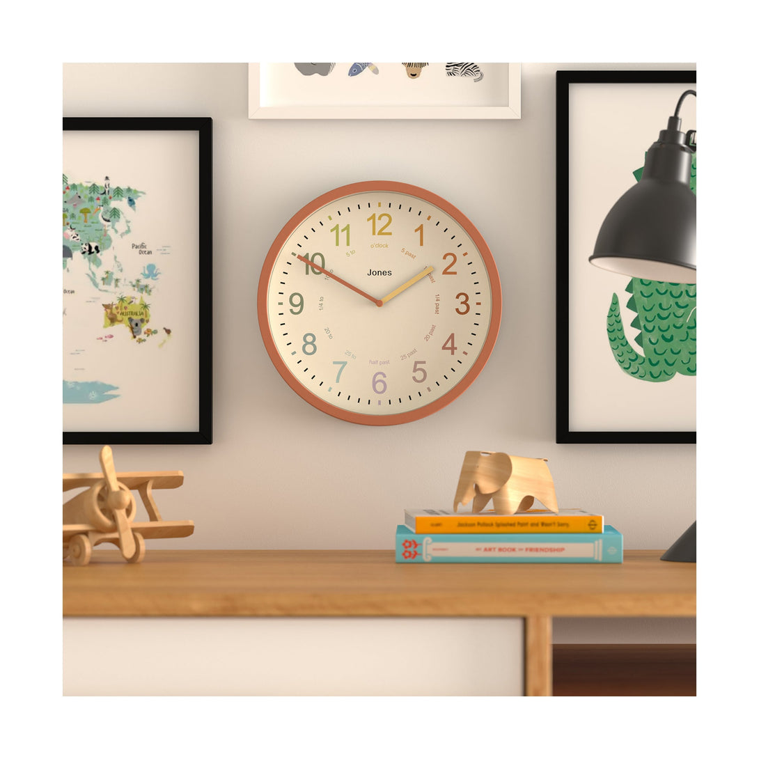 Kids wall clock by Jones Clocks in terracotta orange with a multi-coloured, easy-to-read dial - JDRAG180TO