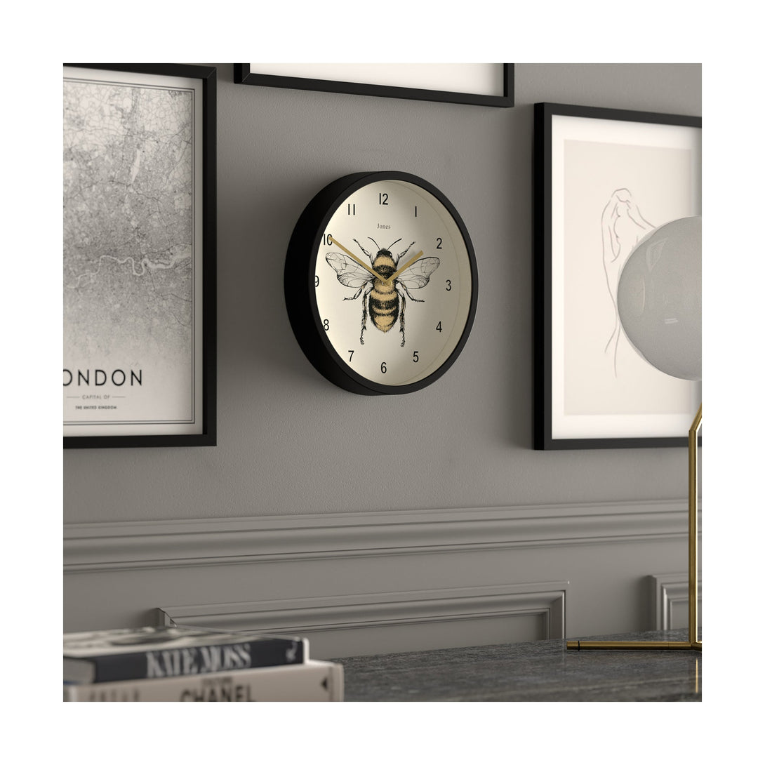 Bee wall clock by Jones Clocks with a black case and modern bee dial - JDRAG277K