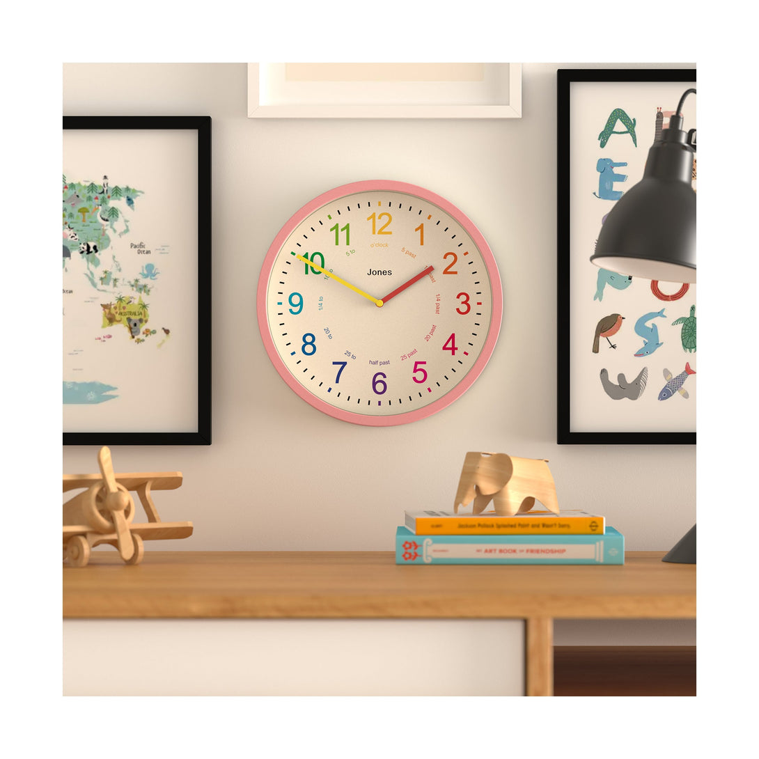 Kids wall clock by Jones Clocks in pink with a multi-coloured, easy-to-read dial - JDRAG73MPK