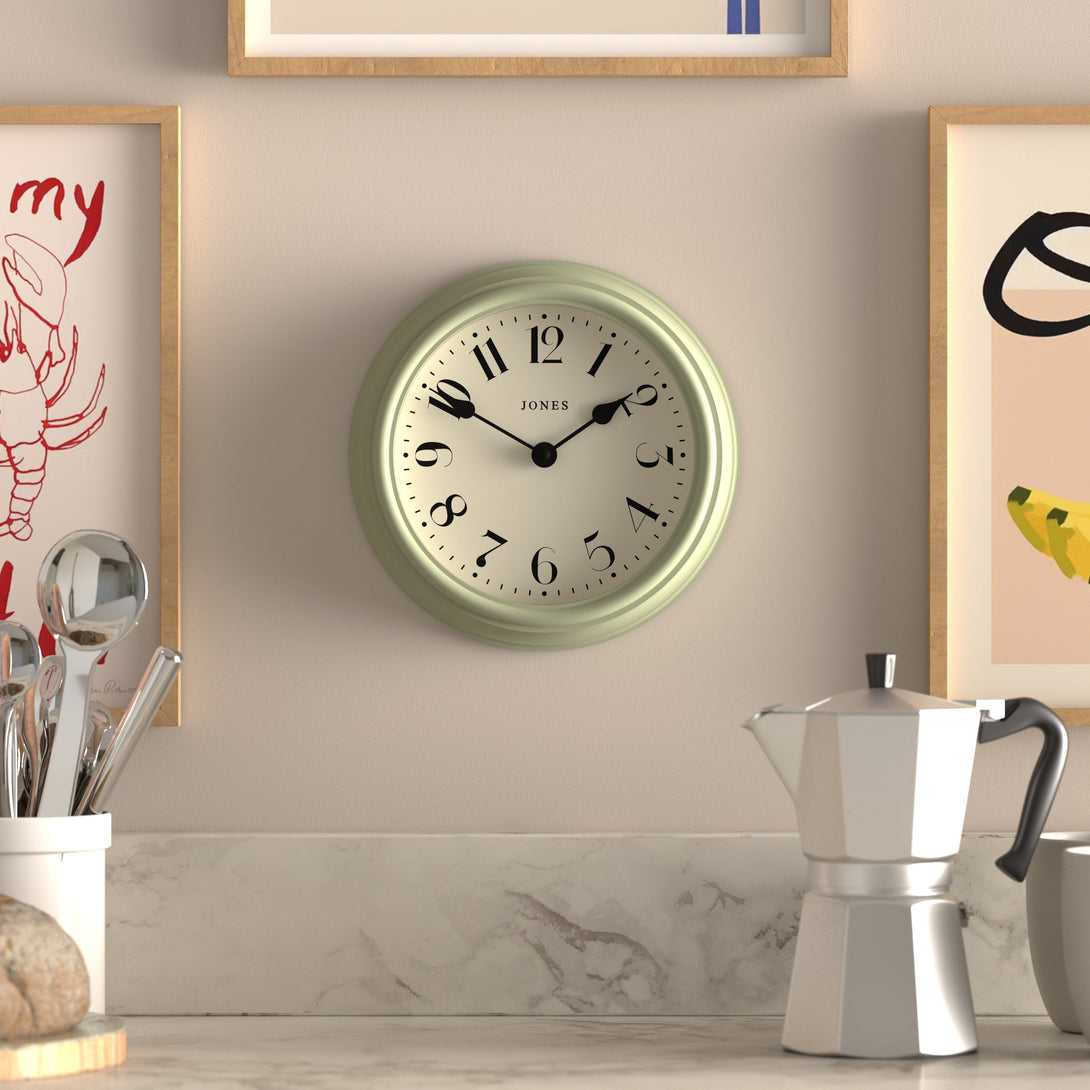 Frieze wall clock by Jones Clocks in sage green with classic Arabic dial and spade hands - JFRZ111DS