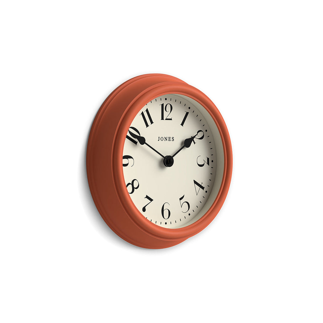 Side view - Frieze wall clock by Jones Clocks in Terracota orange with classic Arabic dial and spade hands - JFRZ111TO