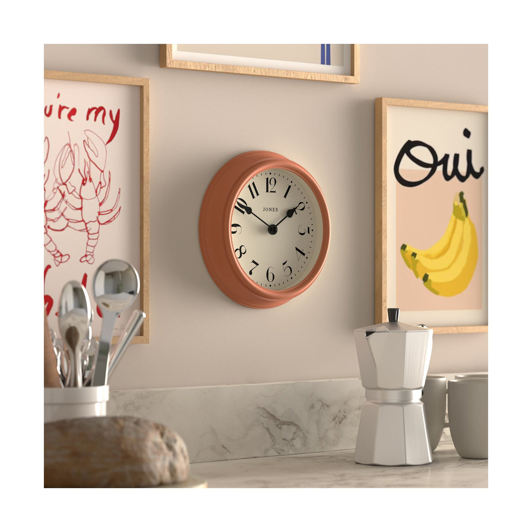 Frieze wall clock by Jones Clocks in Terracota orange with classic Arabic dial and spade hands - JFRZ111TO