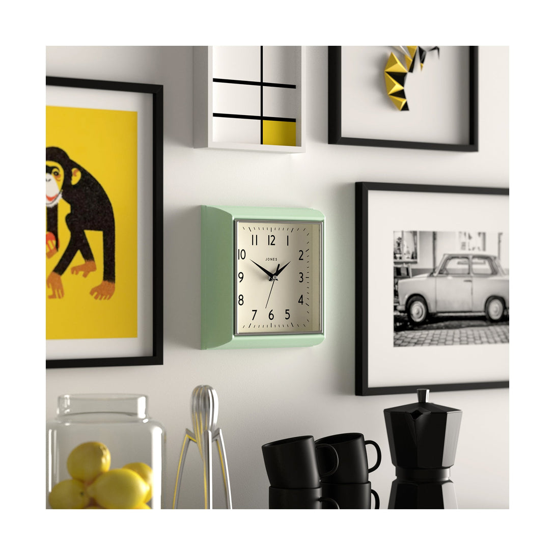 Skew style shot - Mustard wall clock by Jones Clocks in mint green with a square retro style case and a contemporary dial - JMUST741NM