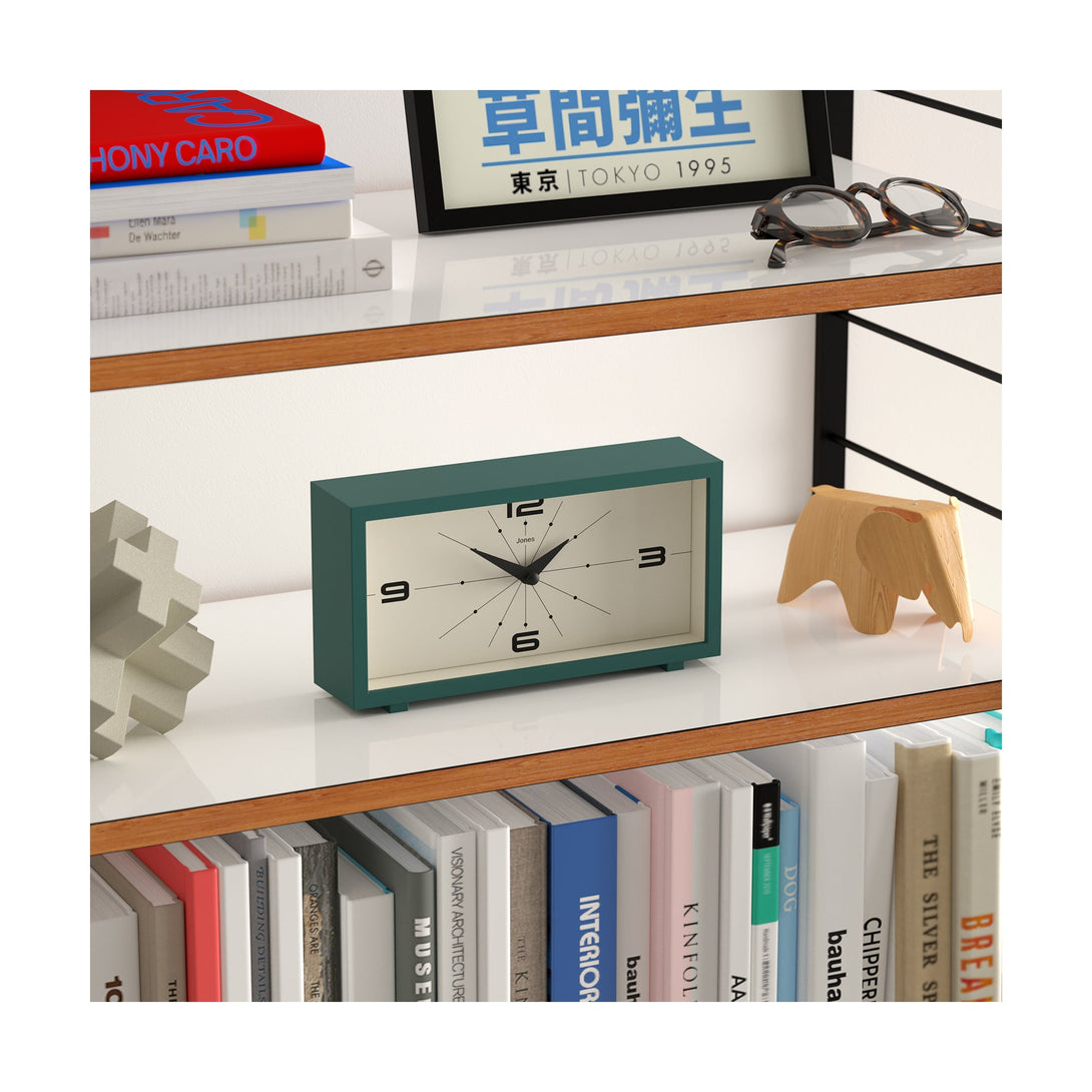 Skew style shot - Odeon mantel clock by Jones Clocks in eden green with a retro-inspired dial and simplified numerals, for mantelpiece, shelving, or desks - JODE95EDG