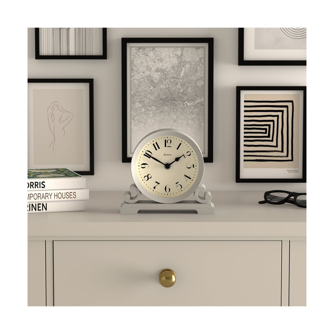 Style shot - Saloon decorative mantel clock by Jones Clocks in cloud grey with a modern stylistic Arabic dial and metal spade hands - JSAL192OGY
