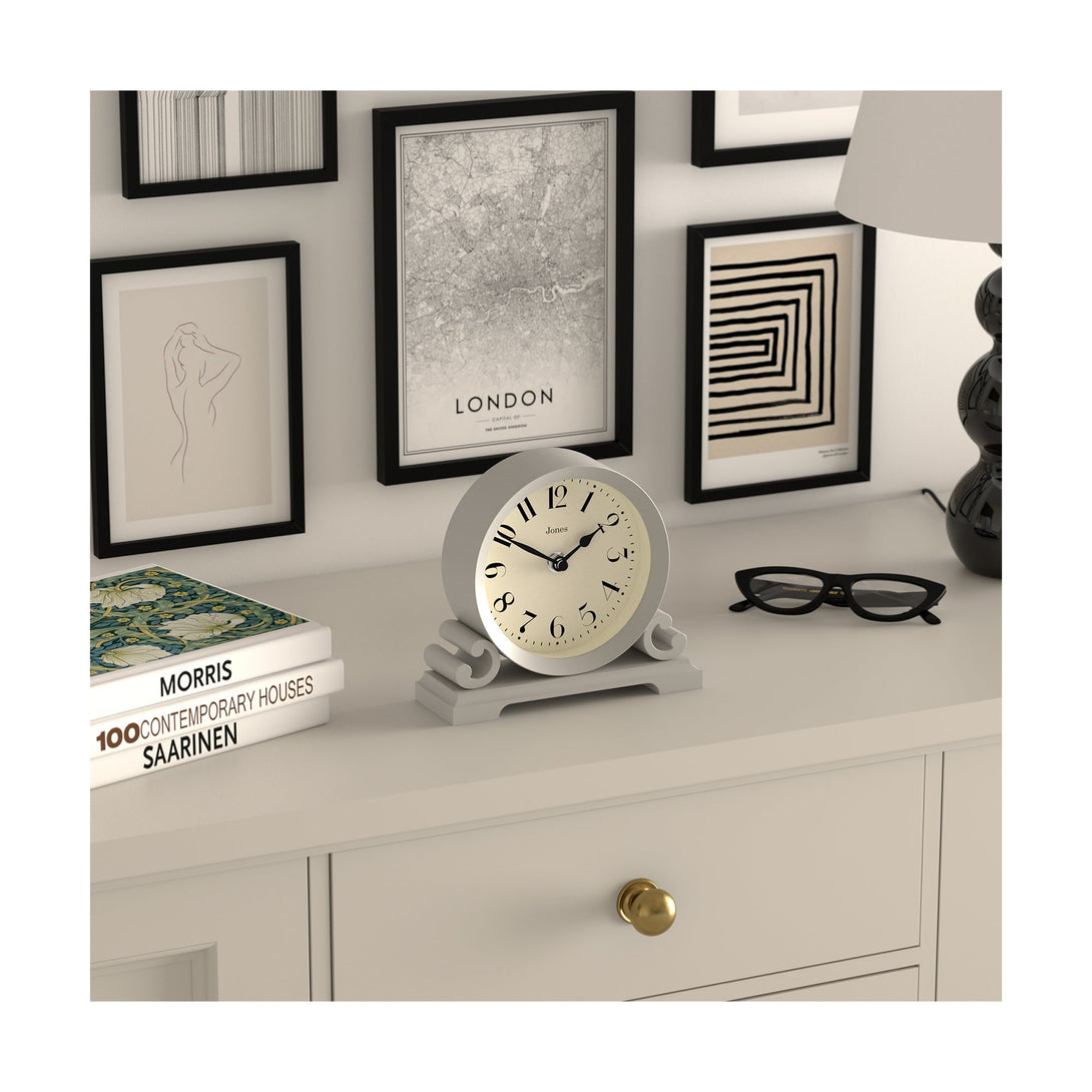 Skew style shot - Saloon decorative mantel clock by Jones Clocks in cloud grey with a modern stylistic Arabic dial and metal spade hands - JSAL192OGY