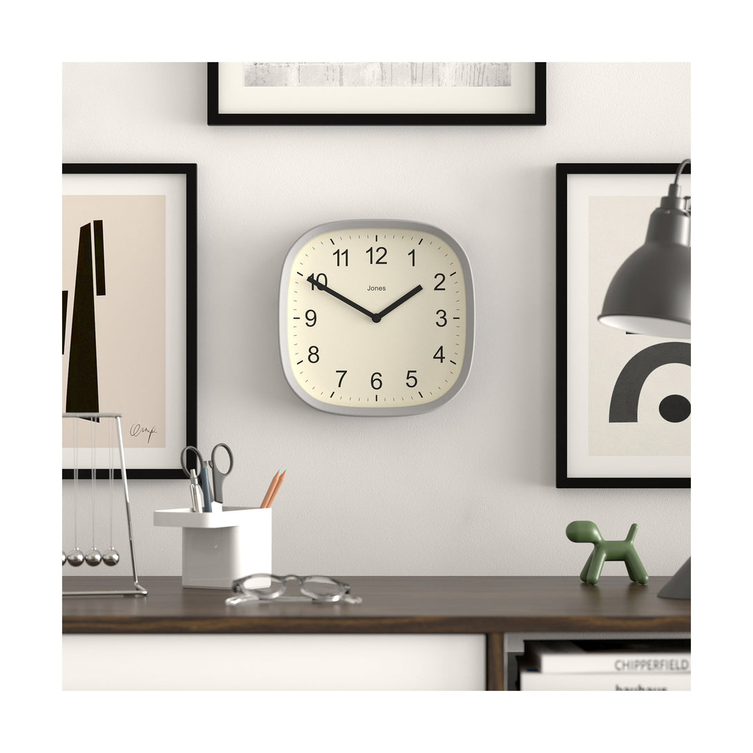 Style shot - Sprite wall clock By Jones Clocks with a rounded square case in a pale grey. Clear contemporary Arabic dial - JSPARV104CGY