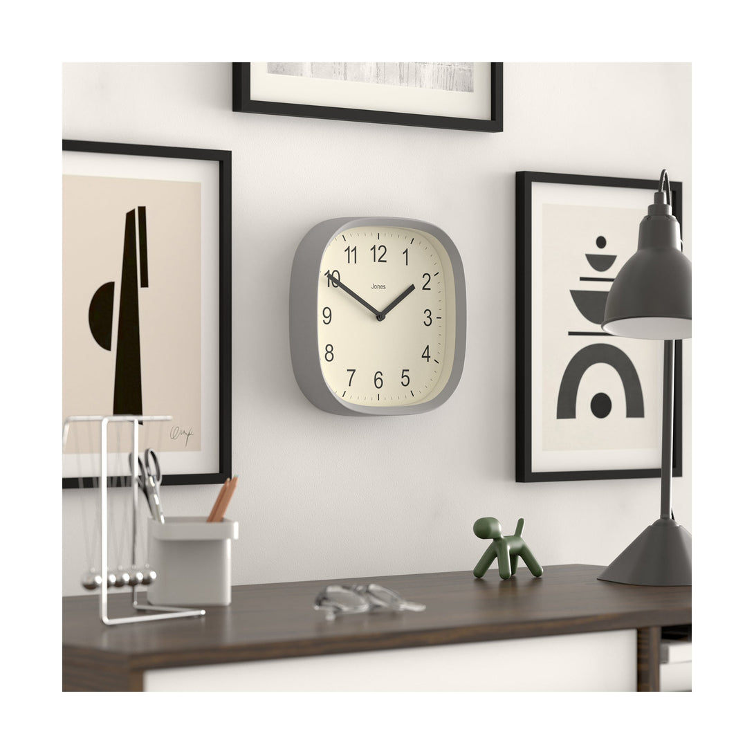 Skew style shot - Sprite wall clock By Jones Clocks with a rounded square case in a pale grey. Clear contemporary Arabic dial - JSPARV104CGY