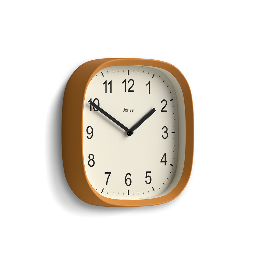 Skew - Sprite wall clock By Jones Clocks with a rounded square case in a mustard yellow. Clear contemporary Arabic dial - JSPARV104MY