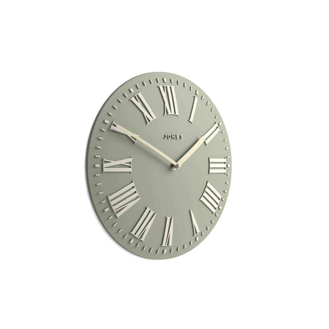 Skew - Strand convex wall clock by Jones Clocks. Prominent white Roman duals on a sage green background, offering a modern look - JSTRSGLW30