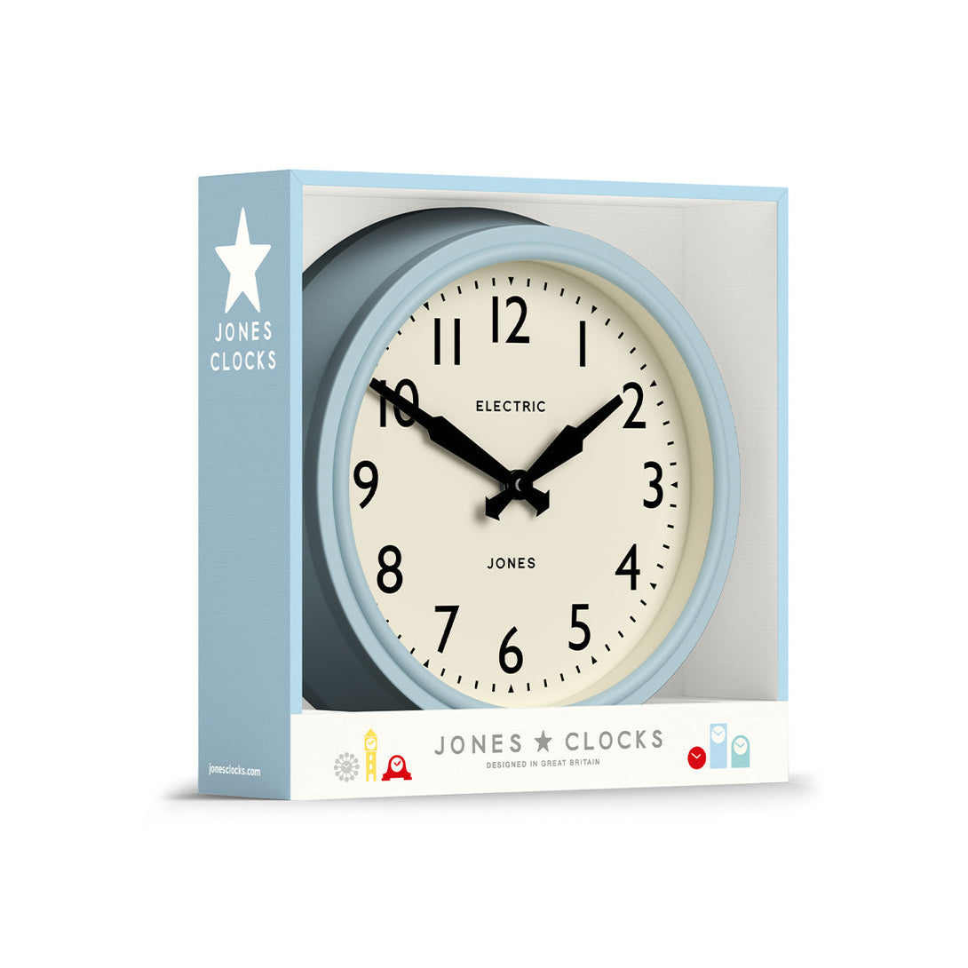 Packaging - Telecom wall clock by Jones Clocks. A mid-century modern case in light blue, bold Arabic dial, and retro propelling hands - JTCOM27CBL