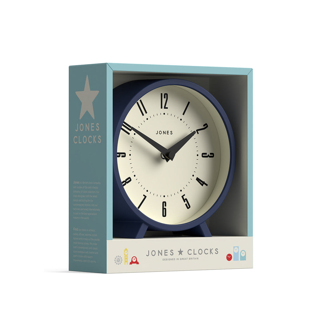 Packaging - Venus mantel clock by Jones Clocks. A contemporary mantel or desk clock in an indigo blue case with triangulation hands, with a retro Arabic dial - JVNU214IBL
