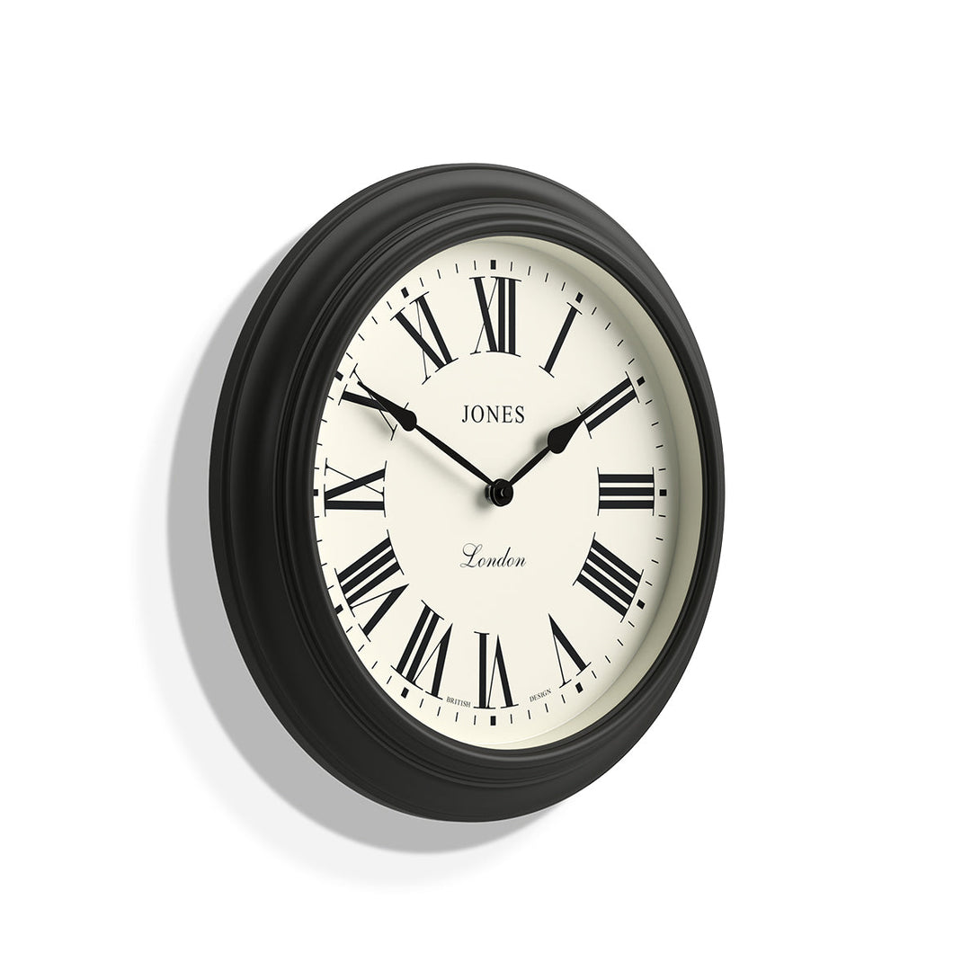 Skew - Large Supper Club wall clock by Jones Clocks. A classic Dark Grey case with a Roman Numeral dial and black spade hands - JSUP319GGY
