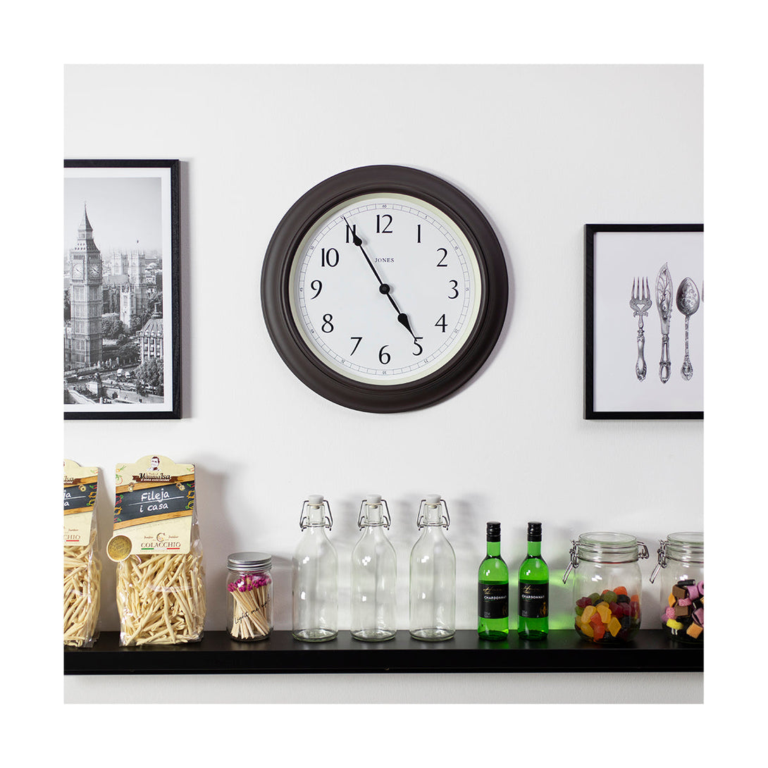 Large, moulded, classic Jones Clocks Supper Club wall clock in Mocha Brown with pretty numerals and double spade hands on a kitchen wall - JSUP163CHK