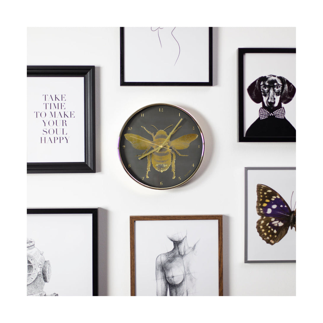 Academy gold Bee wall clock by Jones Clocks with a gold foil and grey dial on a gallery wall - JACA357PB