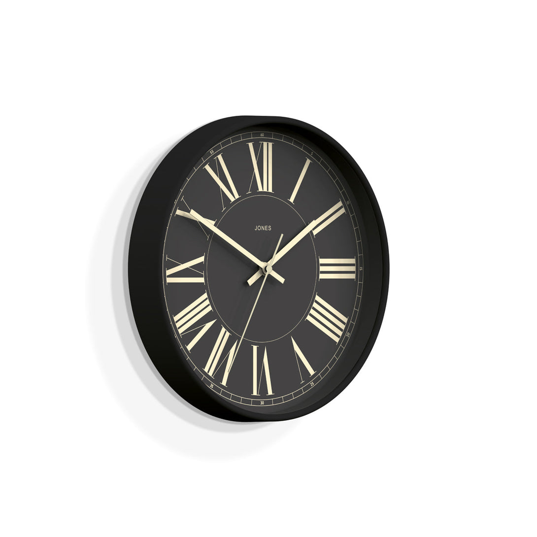 Skew - Studio wall clock by Jones Clocks in charcoal grey with a decorative and classic Roman Numeral dial - JPEN260GGY