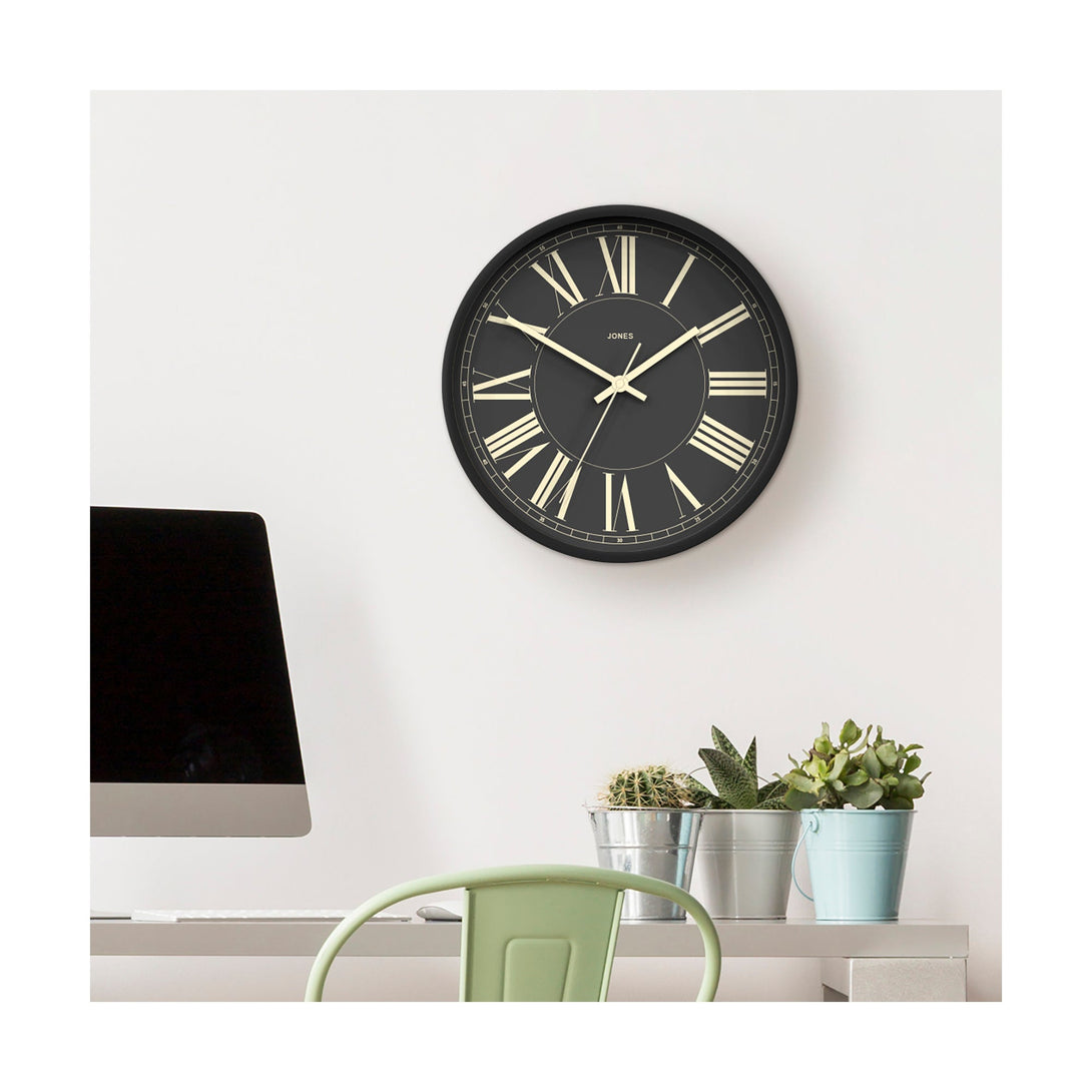 Style shot - Studio wall clock by Jones Clocks in charcoal grey with a decorative and classic Roman Numeral dial - JPEN260GGY