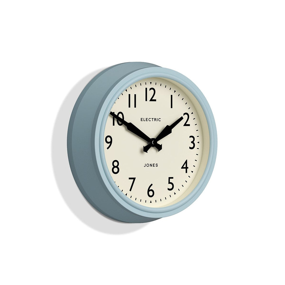 Skew - Telecom wall clock by Jones Clocks. A mid-century modern case in light blue, bold Arabic dial, and retro propelling hands - JTCOM27CBL