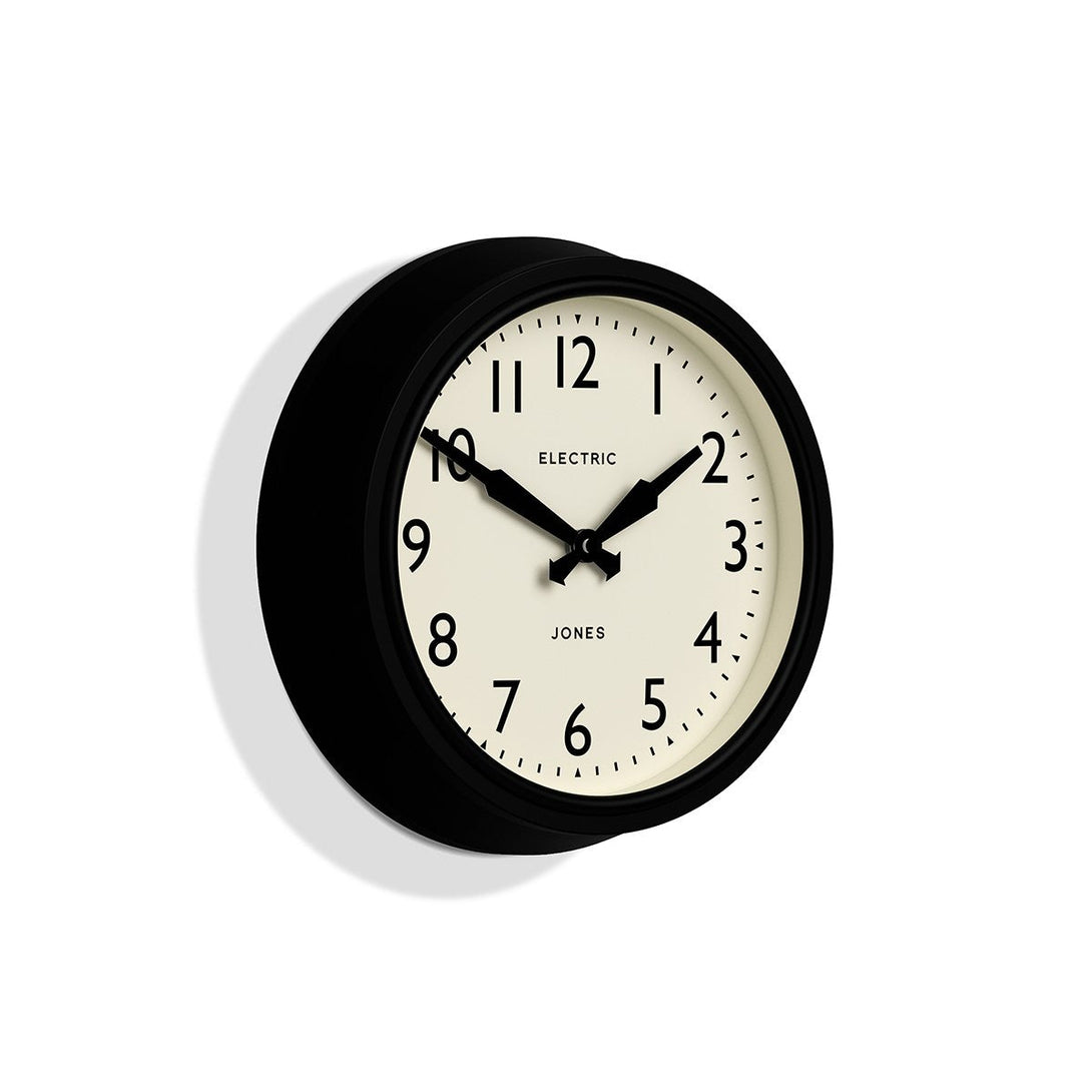 Skew - Telecom wall clock by Jones Clocks. A mid-century modern black case, bold Arabic dial, and retro propelling hands - JTCOM27K
