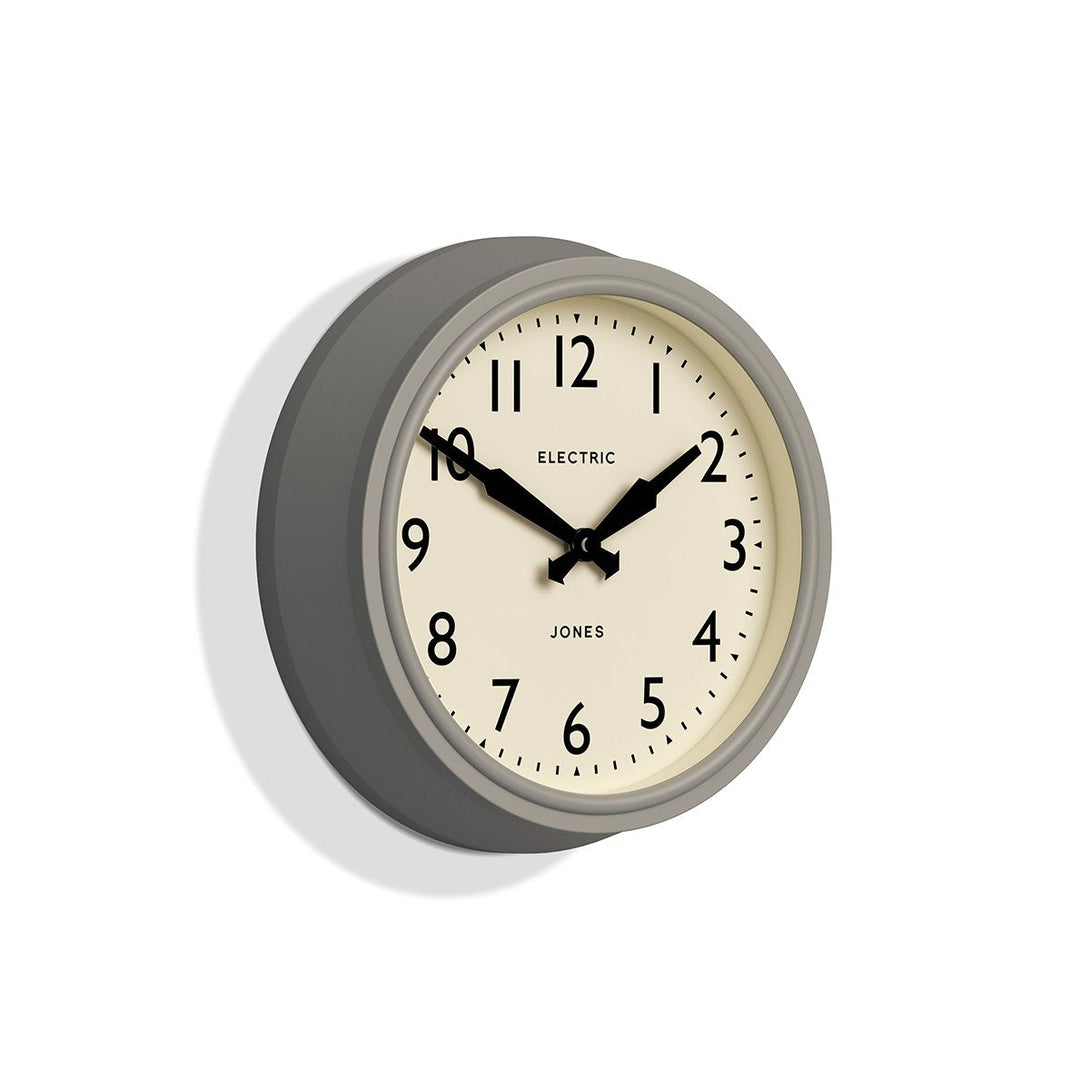 Skew - Telecom wall clock by Jones Clocks. A mid-century modern pepper grey case, bold Arabic dial, and retro propelling hands - JTCOM27PGY