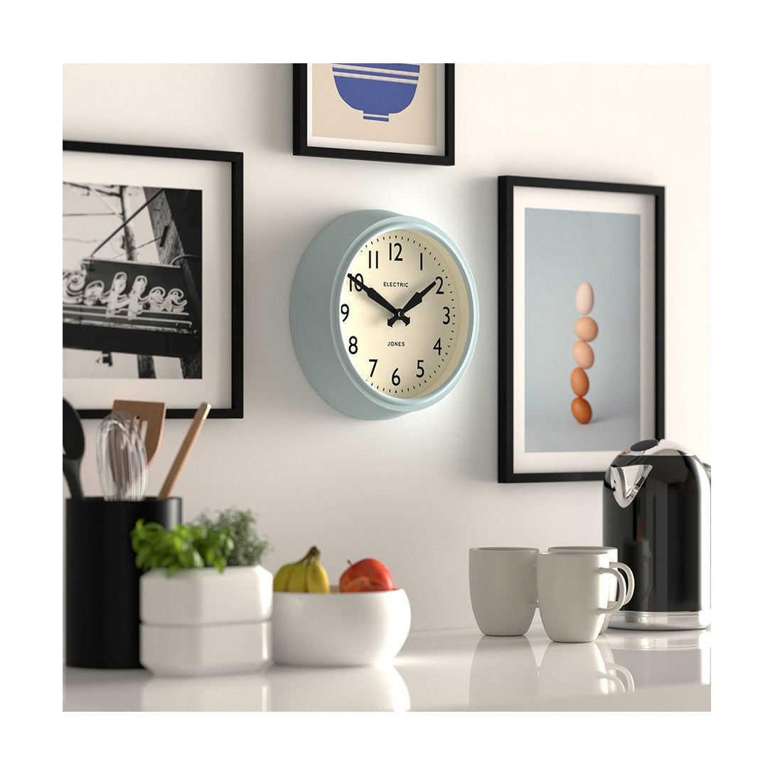 Kitchen skew - Telecom wall clock by Jones Clocks. A mid-century modern case in light blue, bold Arabic dial, and retro propelling hands - JTCOM27CBL