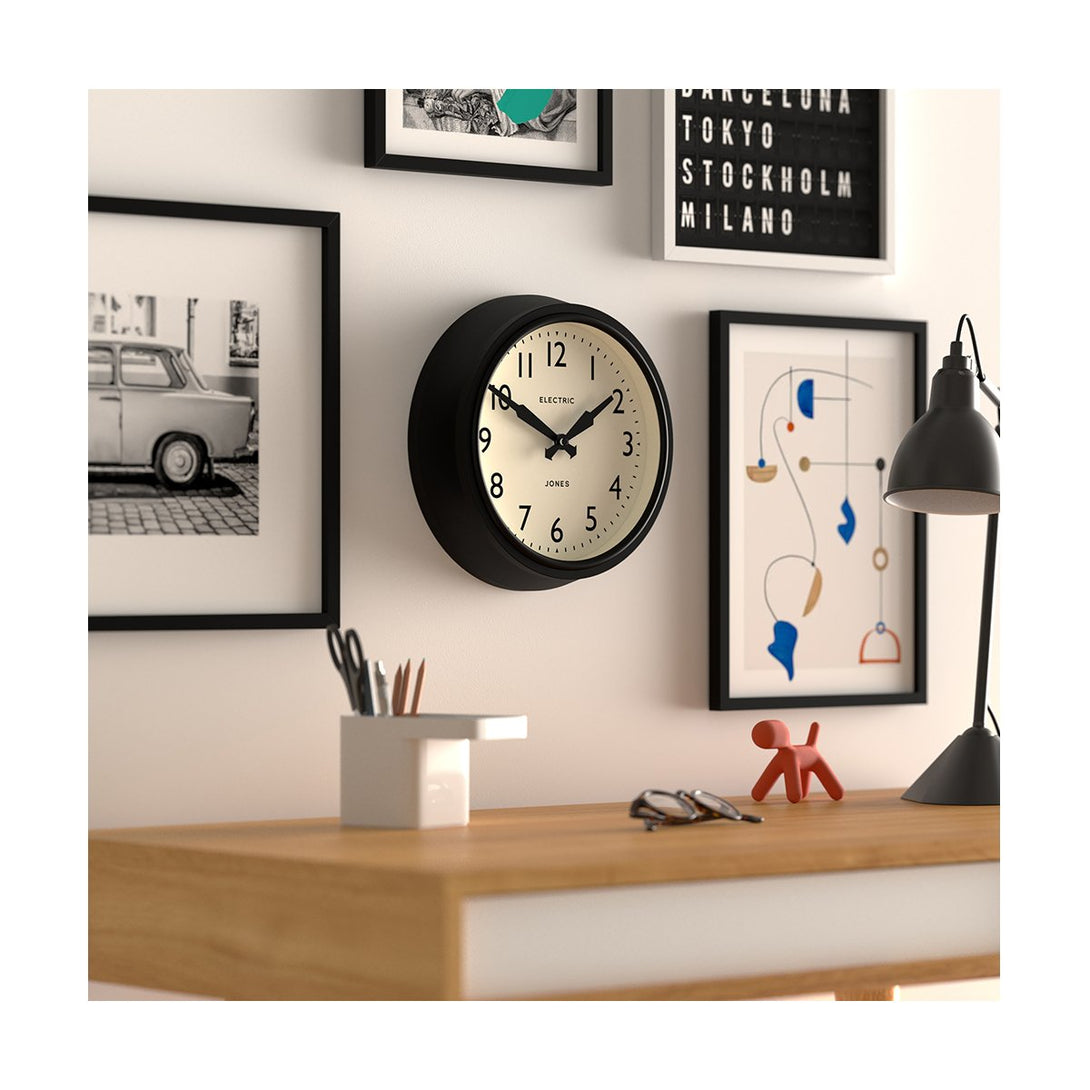 Office skew - Telecom wall clock by Jones Clocks. A mid-century modern black case, bold Arabic dial, and retro propelling hands - JTCOM27K