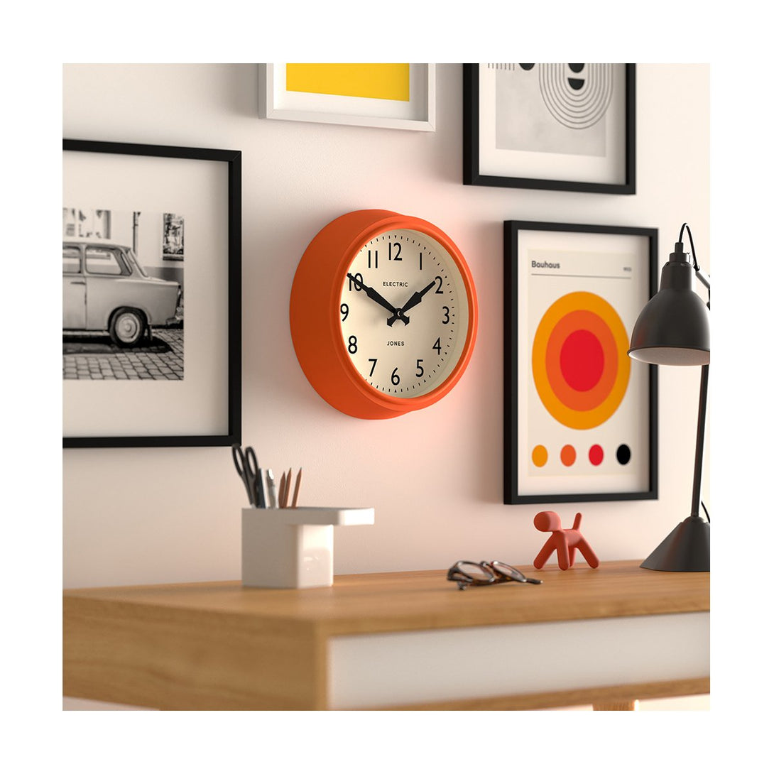 Office skew - Telecom wall clock by Jones Clocks. A mid-century modern orange case, bold Arabic dial, and retro propelling hands - JTCOM27PO