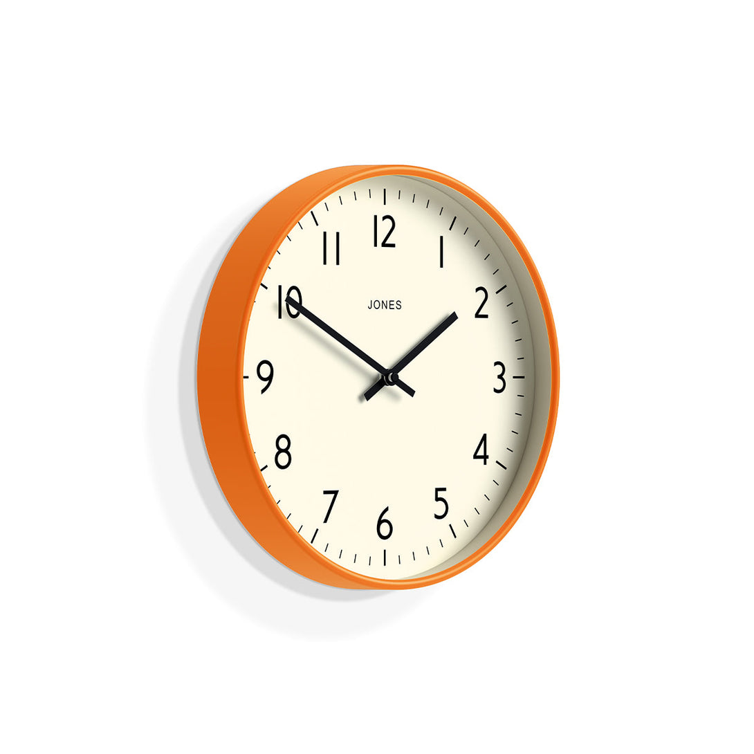 Skew - Studio wall clock by Jones Clocks in orange with an easy-to-read and minimalistic dial - JPEN52FO