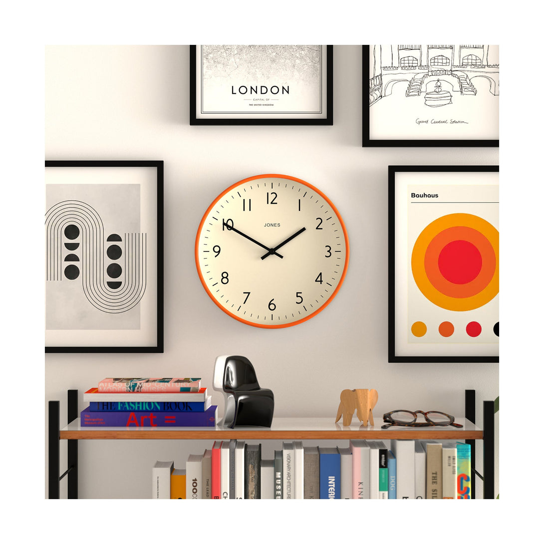 Style shot - Studio wall clock by Jones Clocks in orange with an easy-to-read and minimalistic dial - JPEN52FO