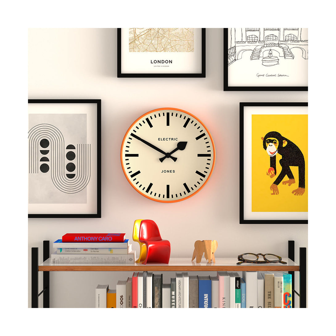 Style shot - Tiger wall clock by Jones Clocks. A contemporary 'fizzy' orange case paired with a bold black railway dial and spade / baton black hands - JTIG38FO