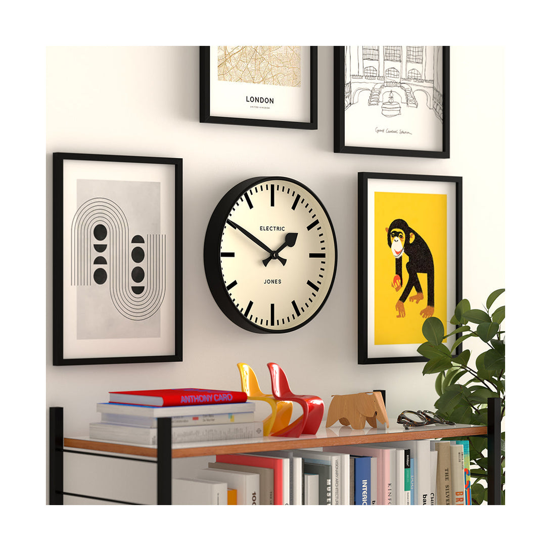 Style shot 2 - Tiger wall clock by Jones Clocks. A contemporary black case paired with a bold black railway dial and spade / baton black hands - JTIG38K